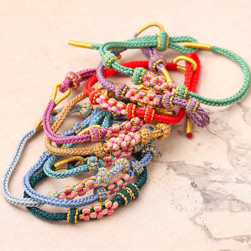 Braccialetto fatto a mano Buddha Stones con tre fiori di pesco e otto fili di corda intrecciata