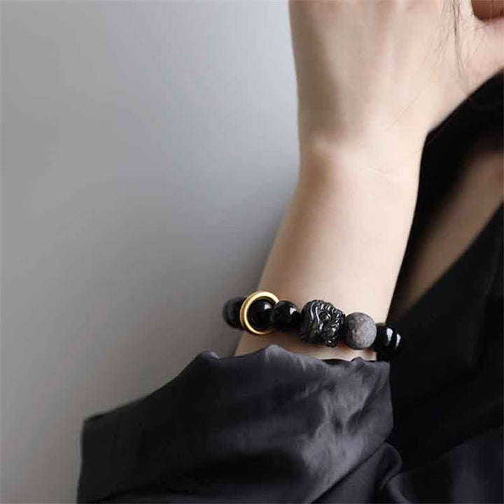Bracciale in ossidiana nera, argento lucido e forza del leone