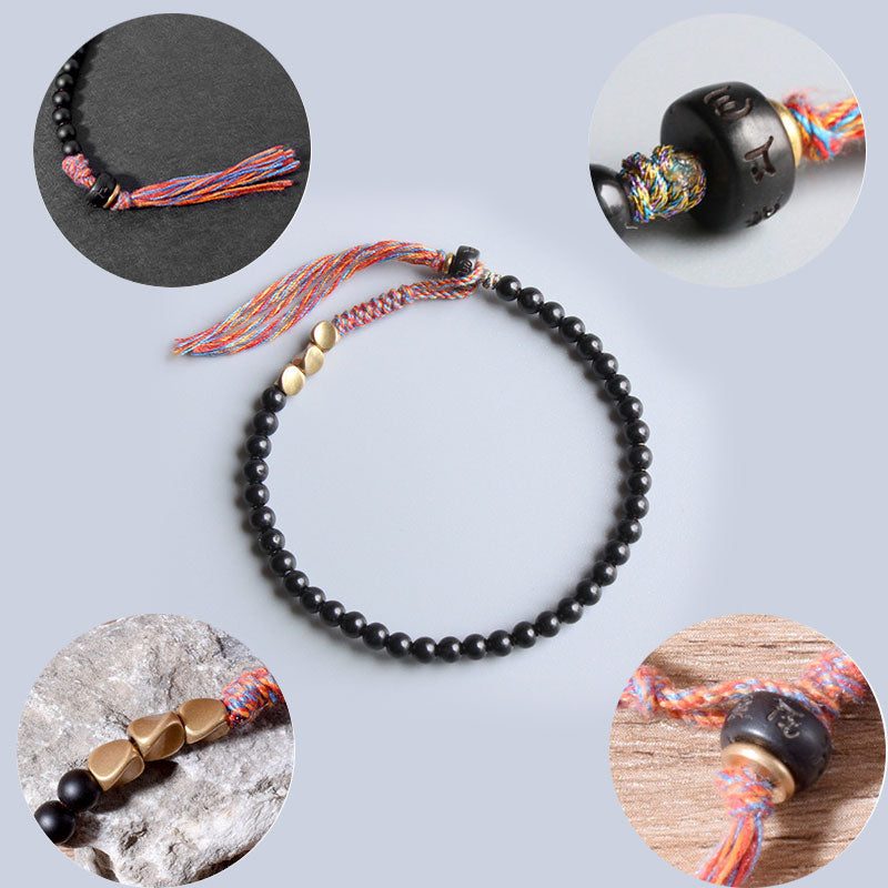 Braccialetto fatto a mano in onice nero tibetano con nappa Buddha Stones