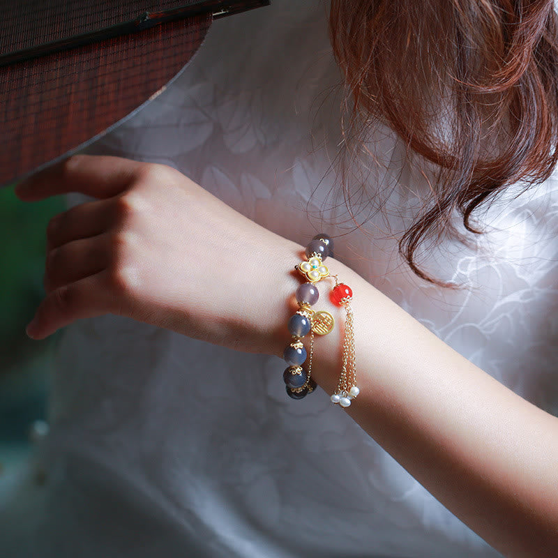 Braccialetto di equilibrio con nappa di perle di carattere Fu in agata grigia naturale Buddha Stones