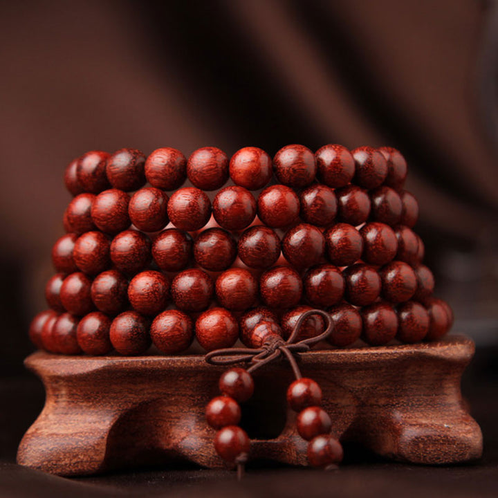 Braccialetto di meditazione Mala con 108 perle di legno di sandalo rosso e foglie piccole tibetane Buddha Stones