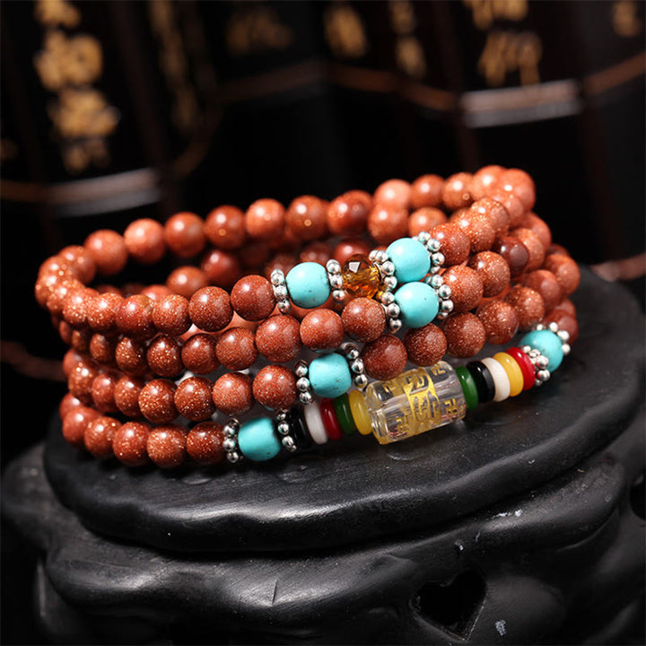 Buddha Stones 108 Mala Beads Goldstone Om Mani Padme Hum Swastika Braccialetto di Fiducia