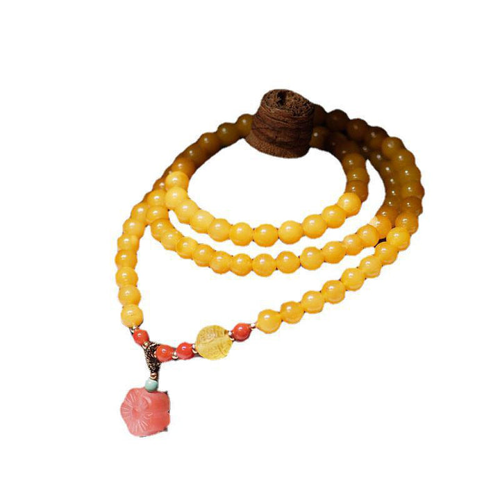 Collana con ciondolo a forma di fiore in ambra curativa e bilanciata