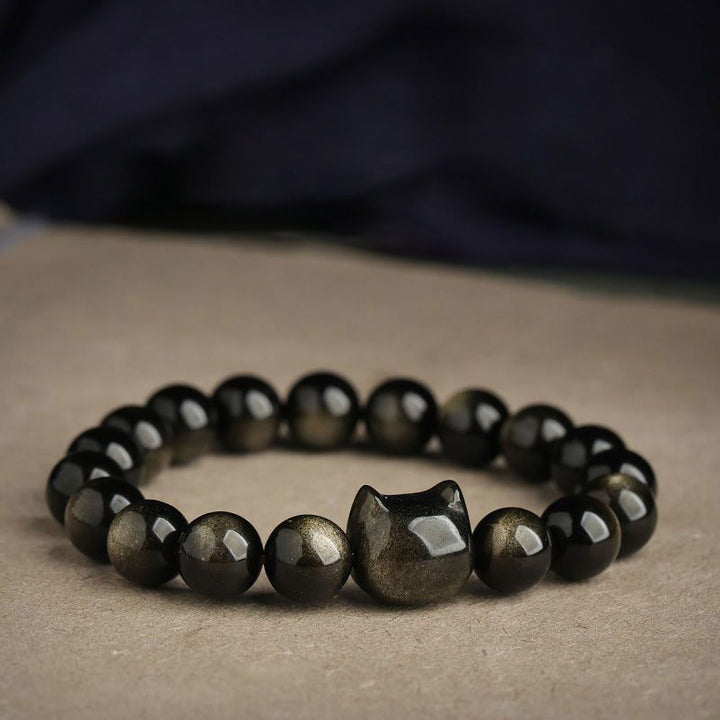 Braccialetto di protezione con gatto portafortuna e zampa adorabile , Buddha Stones, ossidiana lucida d'oro, ossidiana lucida d'argento - Ossidiana lucente dorata - Testa di gatto - 8 millimetri - image 1
