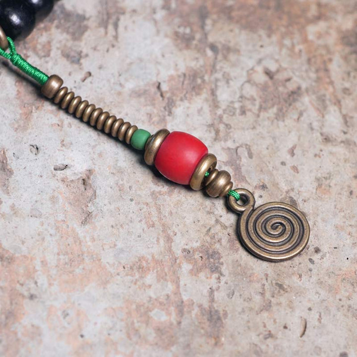 Buddha Stones 108 Perline Mala Legno di Ebano Dzi Perline Rame Braccialetto con Nappa