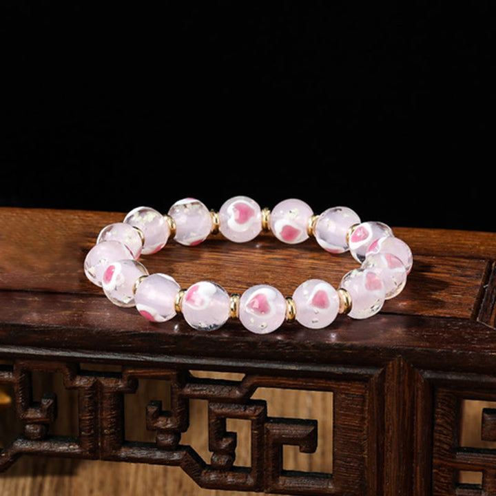 Braccialetto di perline di vetro fluorescente luminoso Liuli con cuore rosa della famiglia di bestie che ingoiano Buddha Stones