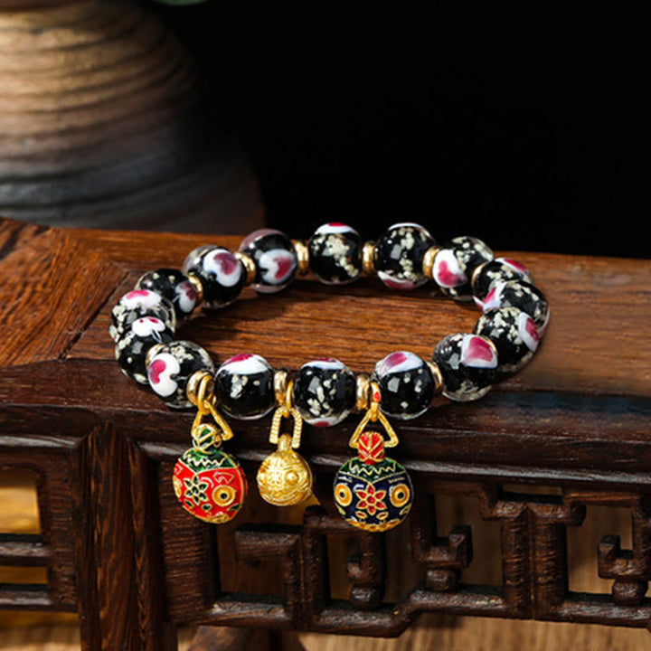 Braccialetto di perline di vetro fluorescente luminoso Liuli con cuore rosa della famiglia di bestie che ingoiano Buddha Stones