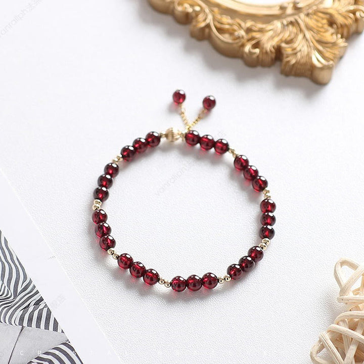 Bracciale Buddha Stones in oro 14K con granato naturale e calma