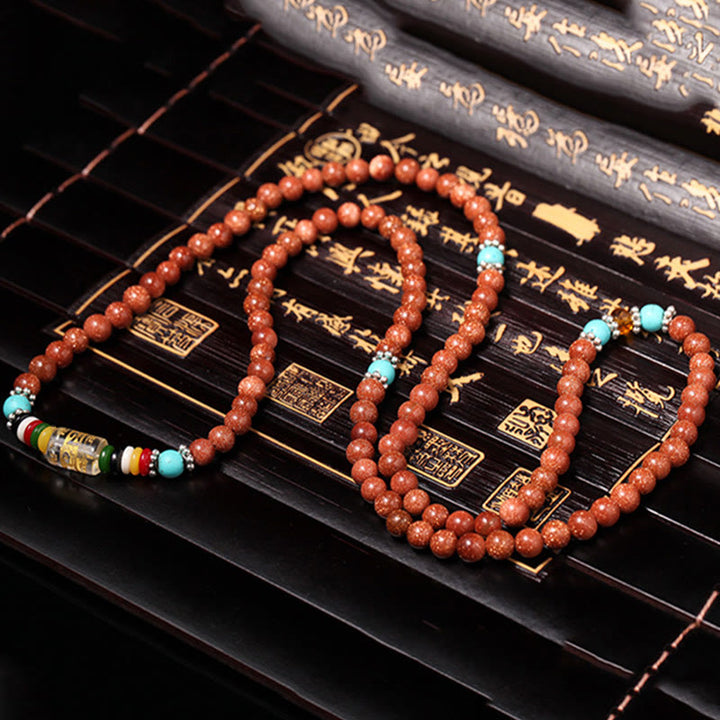 Buddha Stones 108 Mala Beads Goldstone Om Mani Padme Hum Swastika Braccialetto di Fiducia