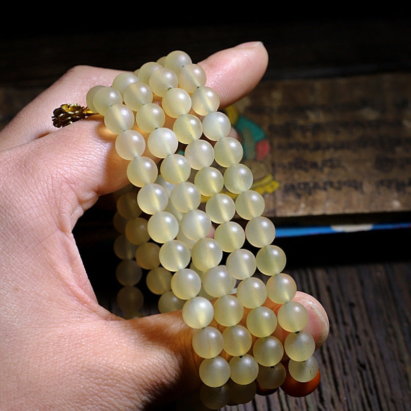 Braccialetto della fortuna in ambra e corno di pecora del Tibet con 108 perle di Mala Buddha Stones