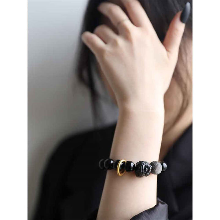 Bracciale in ossidiana nera, argento lucido e forza del leone