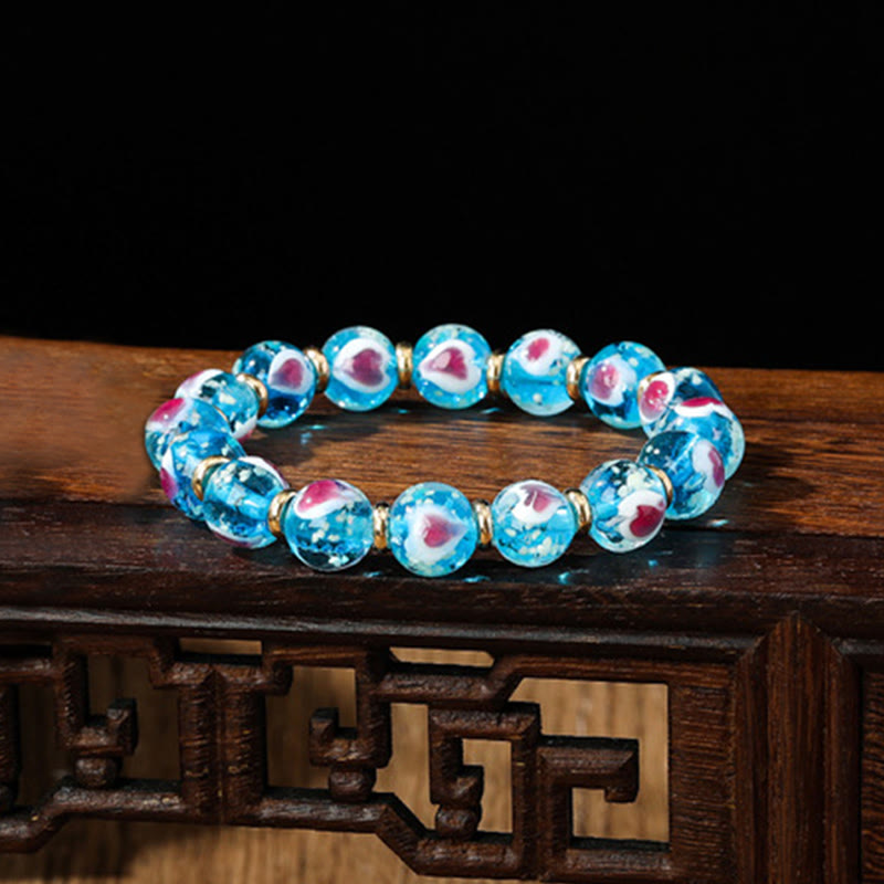 Braccialetto di perline di vetro fluorescente luminoso Liuli con cuore rosa della famiglia di bestie che ingoiano Buddha Stones