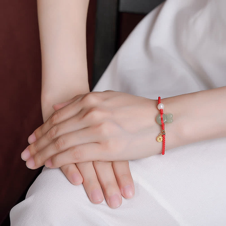 Braccialetto in corda rossa con moneta di rame e giada di Hetian dell'anno del coniglio in argento sterling 925