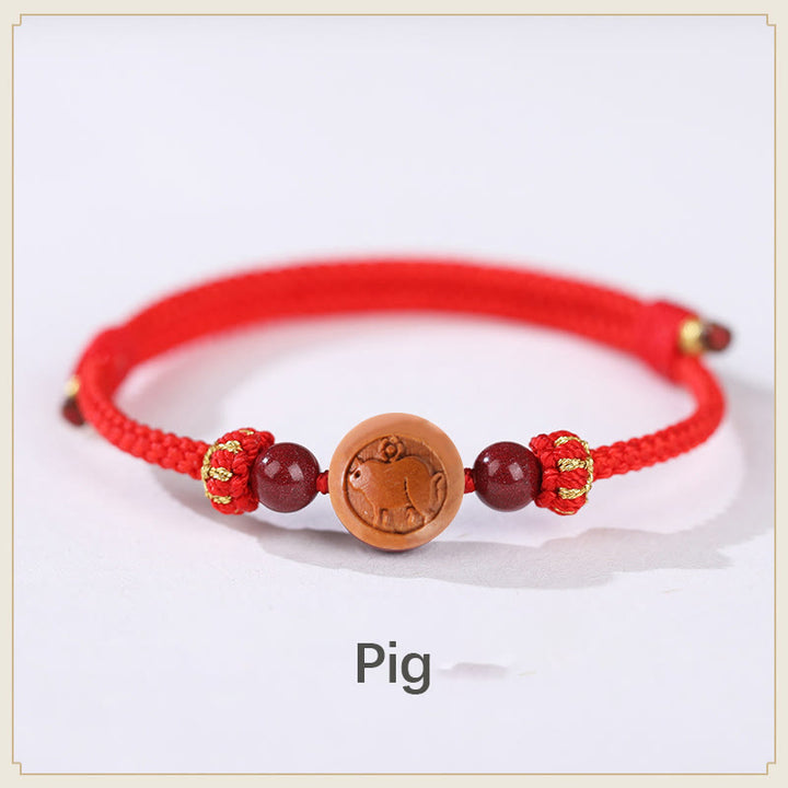 Braccialetto della ricchezza in cinabro intagliato con carattere dello zodiaco cinese Fu in legno di pesca naturale Buddha Stones