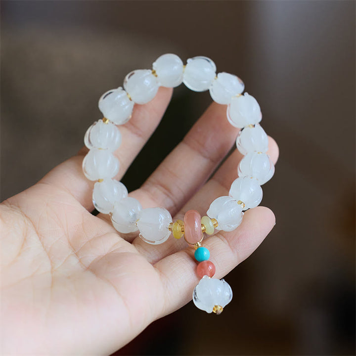Braccialetto dell'illuminazione con ciondolo leone danzante avorio, perline di vetro Liuli, motivo loto, fluorite e Buddha Stones