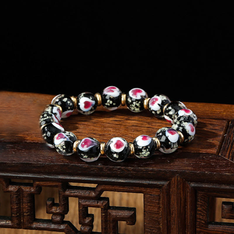 Braccialetto di perline di vetro fluorescente luminoso Liuli con cuore rosa della famiglia di bestie che ingoiano Buddha Stones