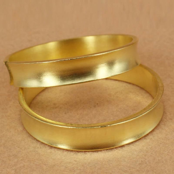 Bracciale rigido in rame con simbolo di ricchezza e fortuna