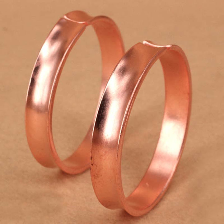 Bracciale rigido in rame con simbolo di ricchezza e fortuna