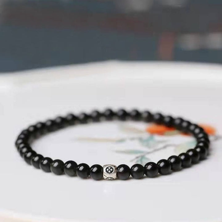 Bracciale Buddha Stones in ossidiana nera naturale e quarzo fumé per la forza di purificazione