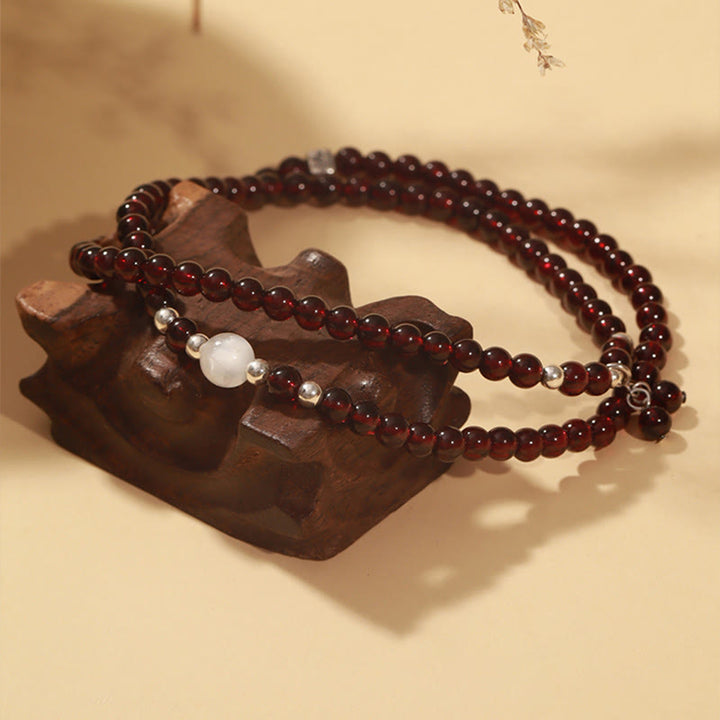 Braccialetto triplo giro Buddha Stones in argento sterling 925 con granato naturale e protezione per gli occhi di gatto