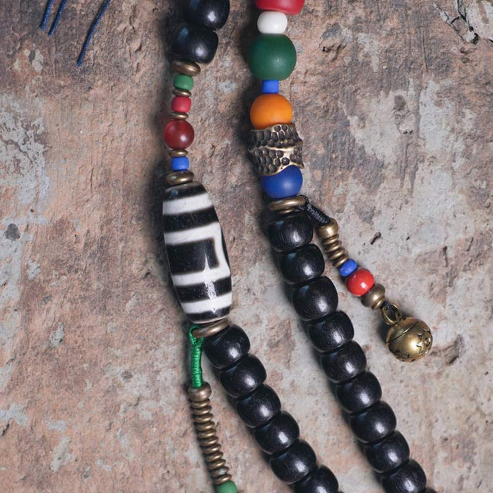 Buddha Stones 108 Perline Mala Legno di Ebano Dzi Perline Rame Braccialetto con Nappa