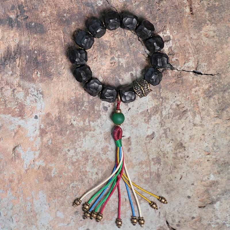 Bracciale Mala da polso con nappa in legno di Buddha Stones tibetano e rame della pace