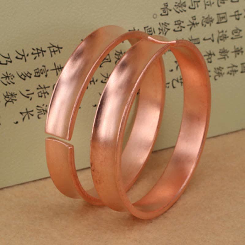 Bracciale rigido in rame con simbolo di ricchezza e fortuna