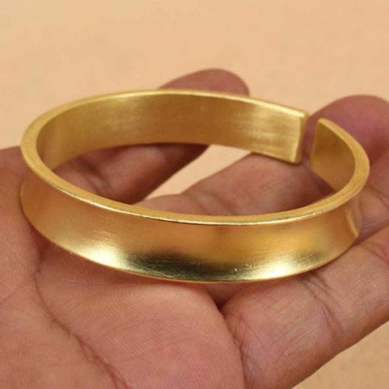 Bracciale rigido in rame con simbolo di ricchezza e fortuna