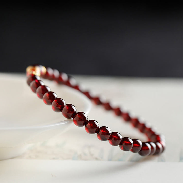 Braccialetto di protezione in granato naturale con pesce koi in oro 999 Buddha Stones