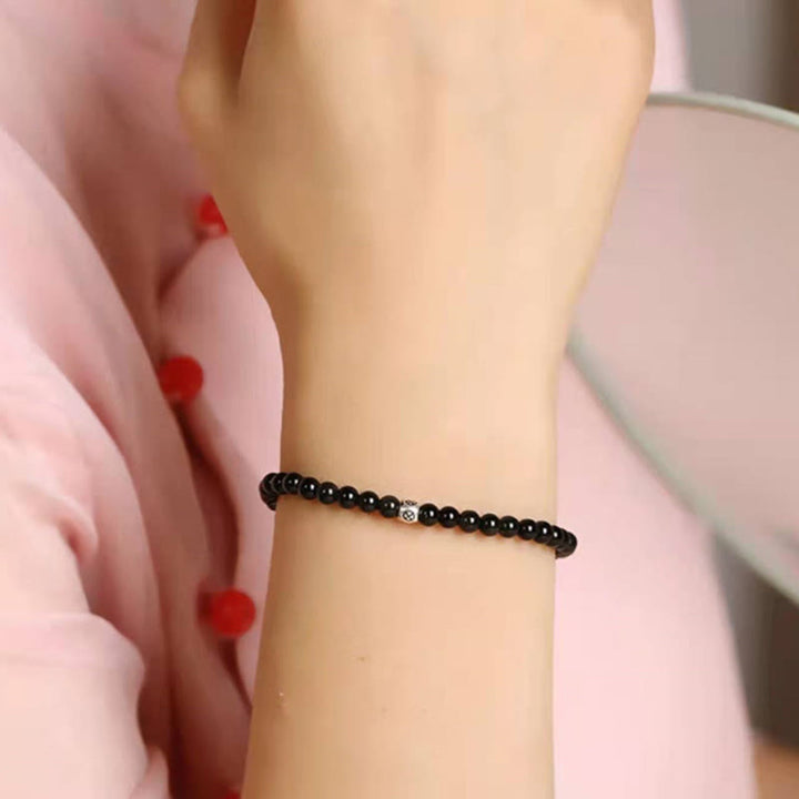 Bracciale Buddha Stones in ossidiana nera naturale e quarzo fumé per la forza di purificazione