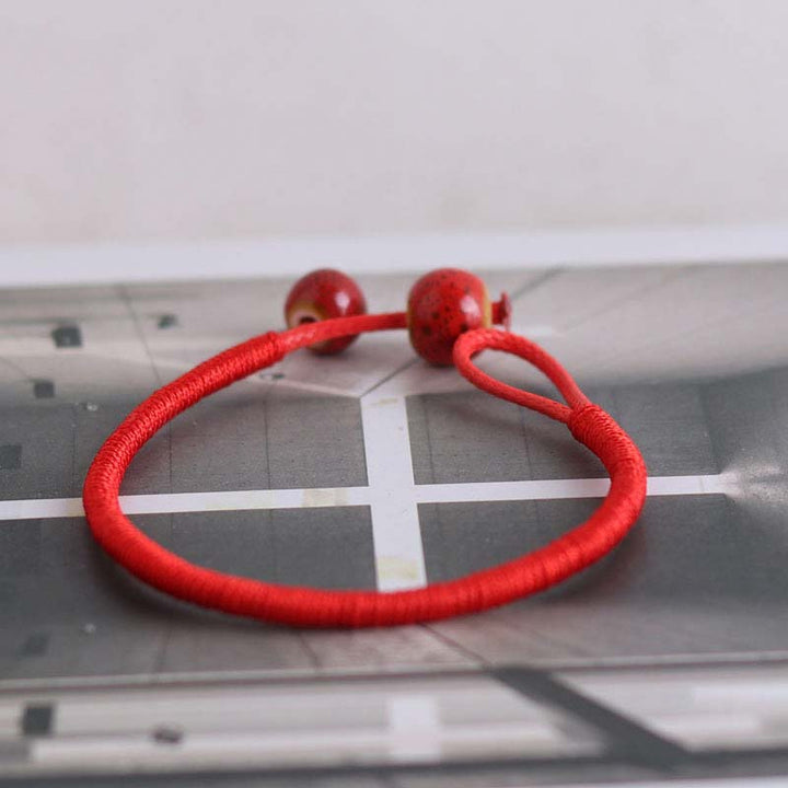 Braccialetto in ceramica con corda rossa portafortuna FengShui Buddha Stones