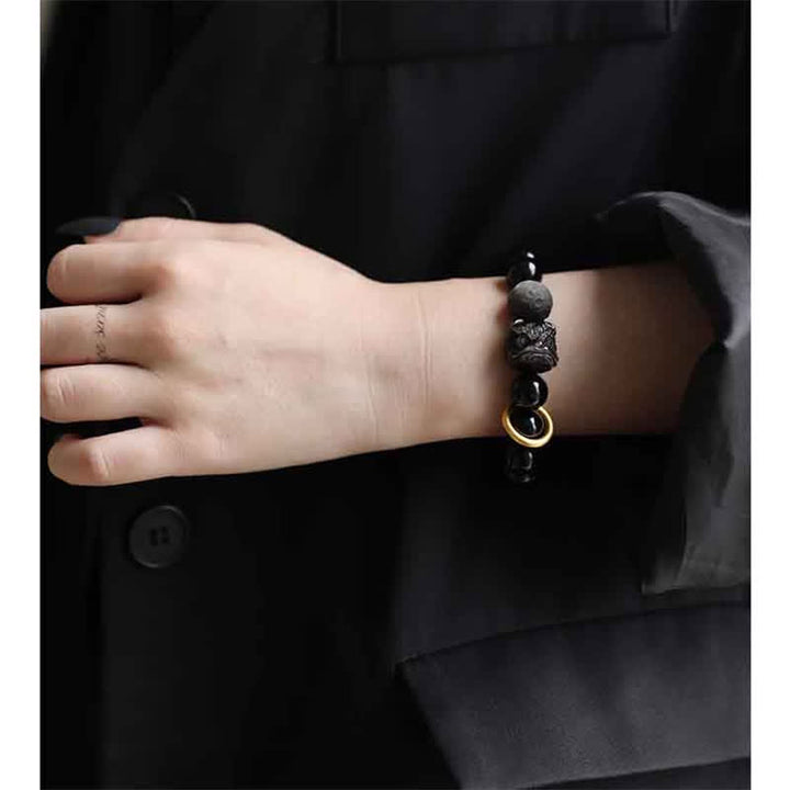 Bracciale in ossidiana nera, argento lucido e forza del leone