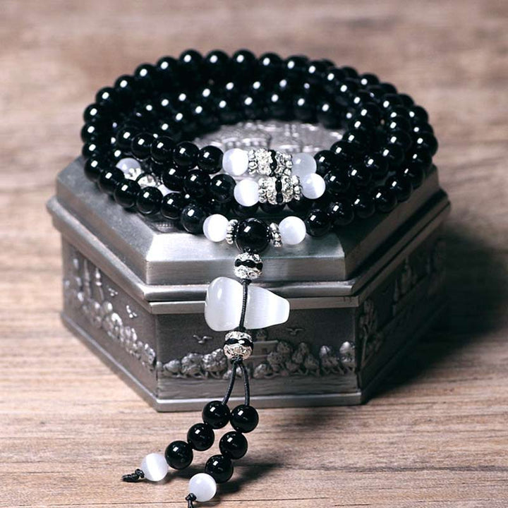 Braccialetto di meditazione con perline di cristallo bianco e onice nero Buddha Stones