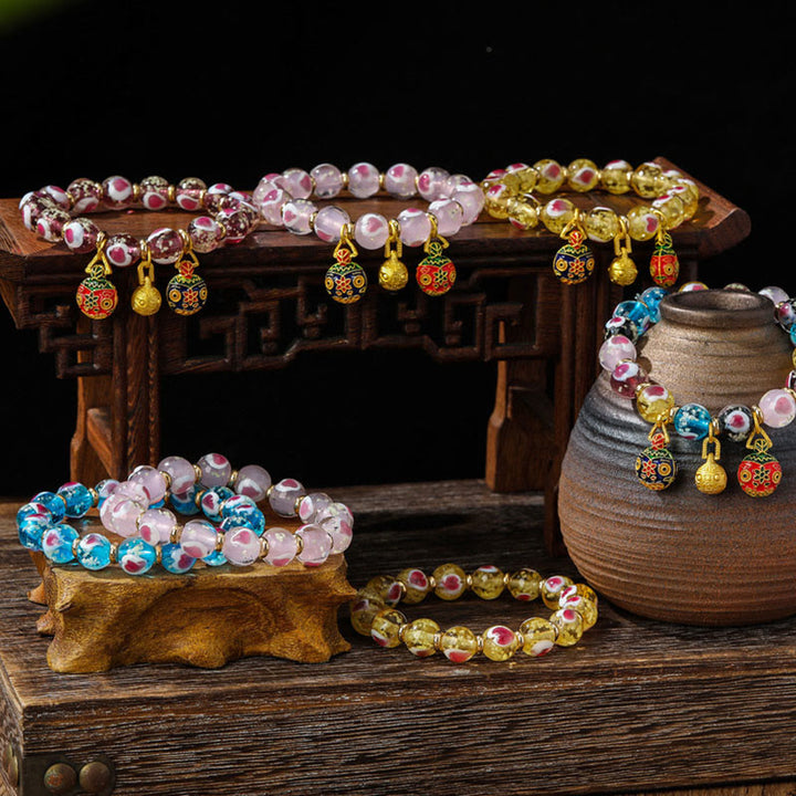 Braccialetto di perline di vetro fluorescente luminoso Liuli con cuore rosa della famiglia di bestie che ingoiano Buddha Stones