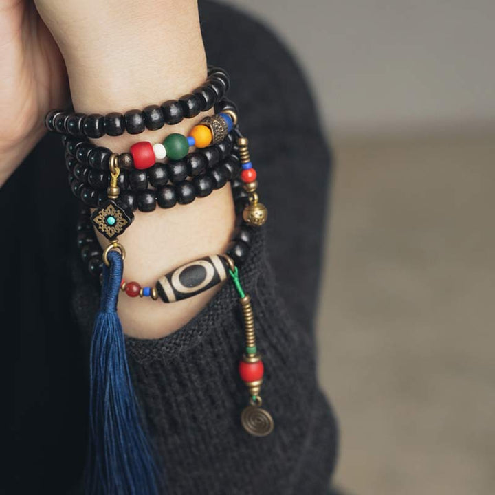 Buddha Stones 108 Perline Mala Legno di Ebano Dzi Perline Rame Braccialetto con Nappa