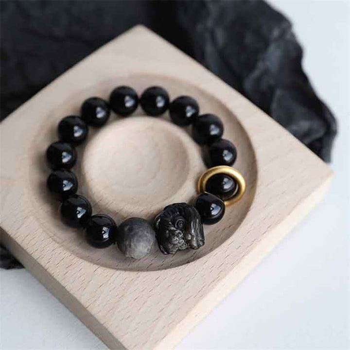 Bracciale in ossidiana nera, argento lucido e forza del leone