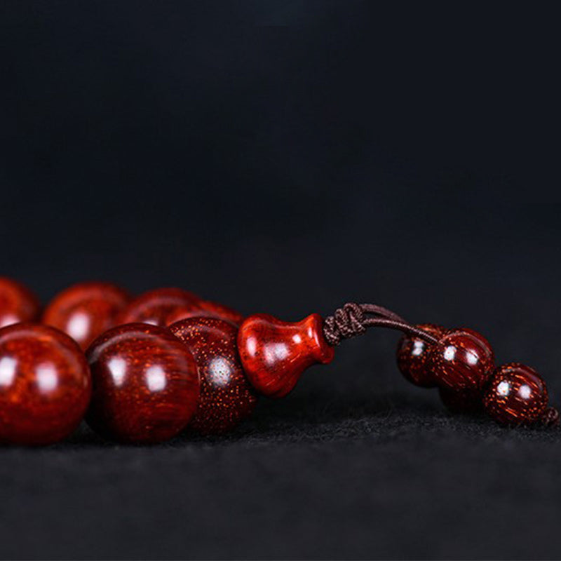 Braccialetto di equilibrio in legno di sandalo rosso con foglia piccola tibetana Buddha Stones