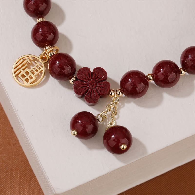 Braccialetto di benedizione con fiori di ciliegio e carattere Fu in pietra di cinabro Buddha Stones