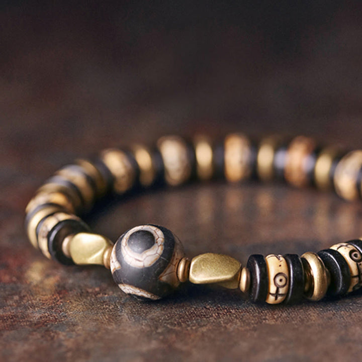 Braccialetto di forza in perline di osso tibetano e legno di ebano con Buddha Stones