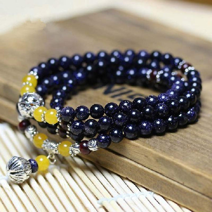 Braccialetto Mala con ciondolo di ricchezza in arenaria blu Buddha Stones