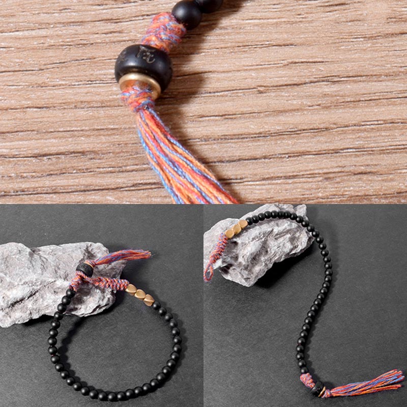 Braccialetto fatto a mano in onice nero tibetano con nappa Buddha Stones