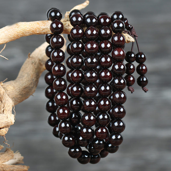 Braccialetto di protezione con nodo cinese in legno di sandalo rosso con piccola foglia e stella d'oro Buddha Stones