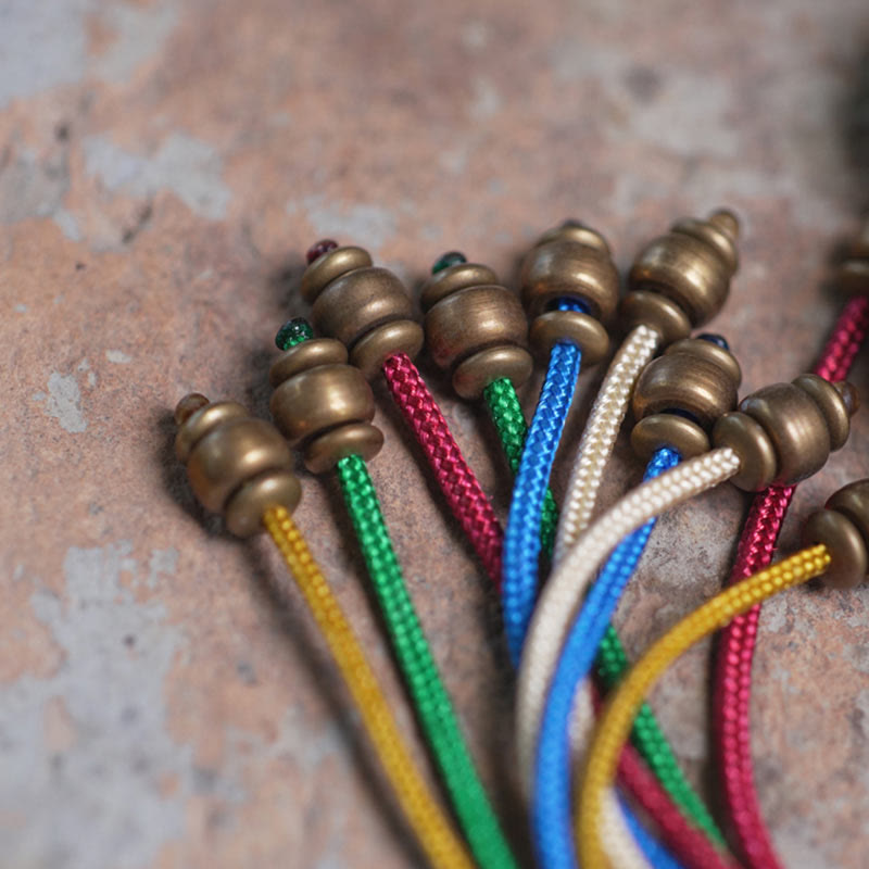 Bracciale Mala da polso con nappa in legno di Buddha Stones tibetano e rame della pace