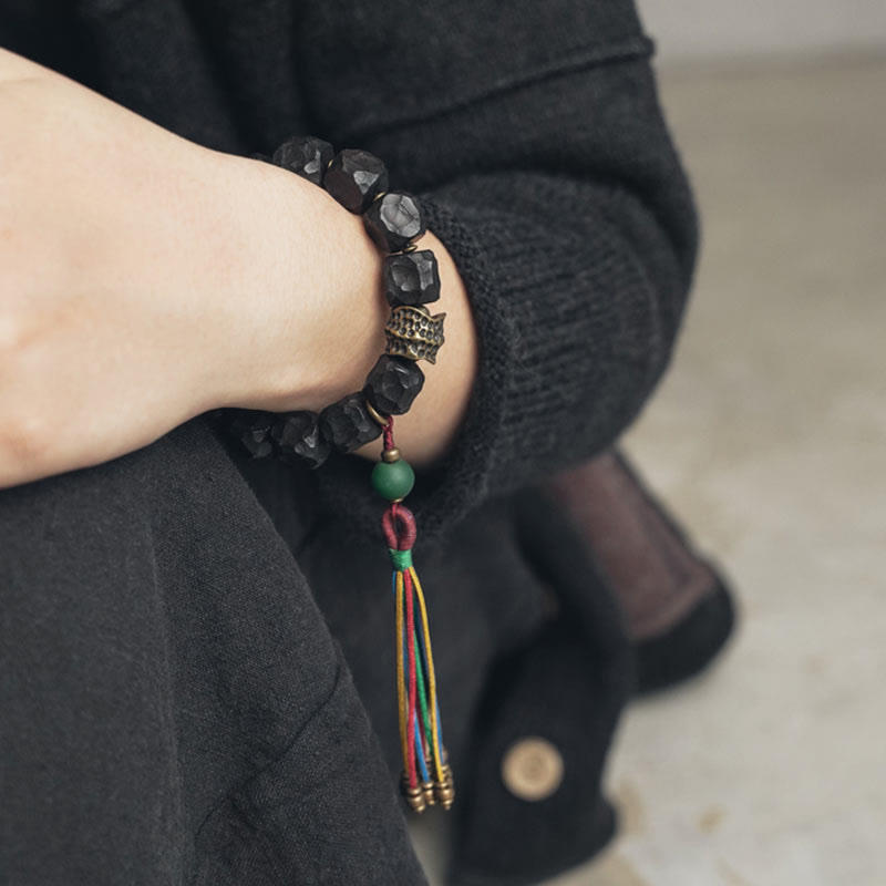 Bracciale Mala da polso con nappa in legno di Buddha Stones tibetano e rame della pace
