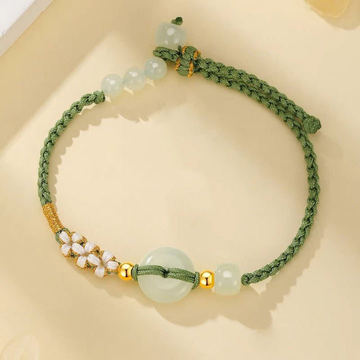 Bracciale intrecciato con Buddha Stones, giada Hetian, fibbia della pace, fortuna e fiori di pesco