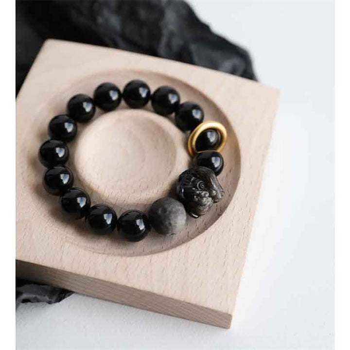 Bracciale in ossidiana nera, argento lucido e forza del leone