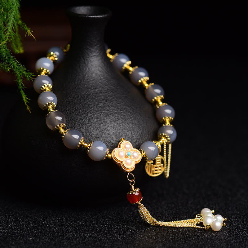 Braccialetto di equilibrio con nappa di perle di carattere Fu in agata grigia naturale Buddha Stones