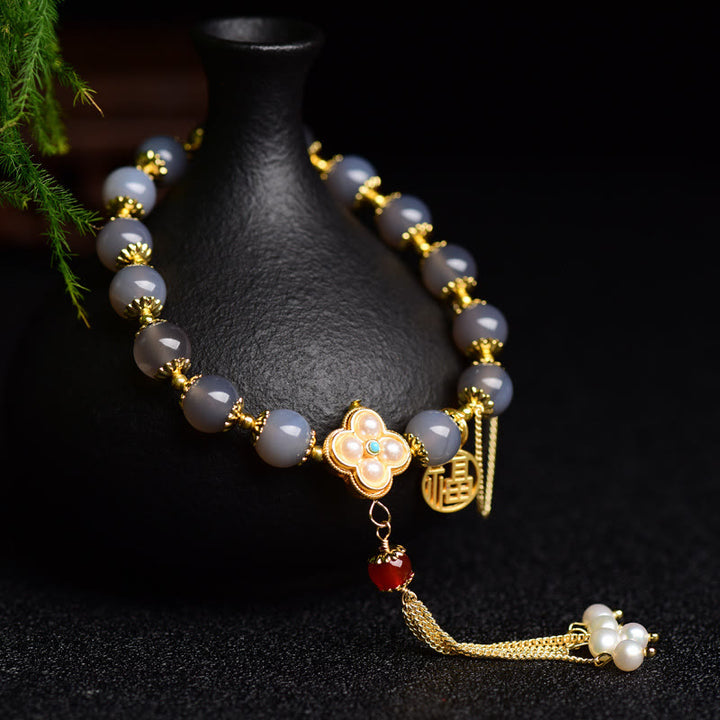 Braccialetto di equilibrio con nappa di perle di carattere Fu in agata grigia naturale Buddha Stones