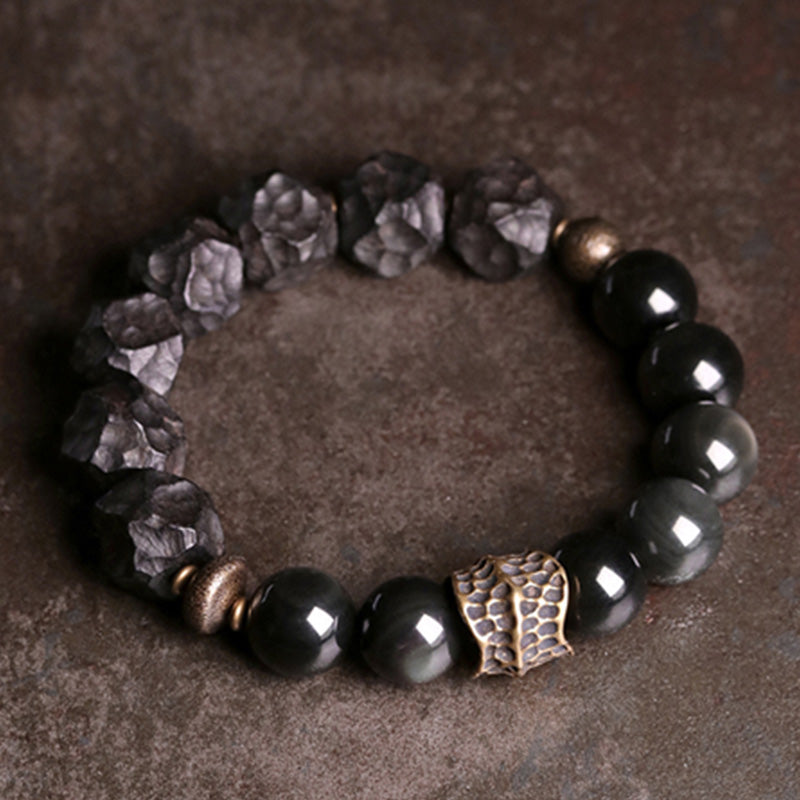 Braccialetto di coppia forza in rame, legno di ebano e ossidiana nera Buddha Stones