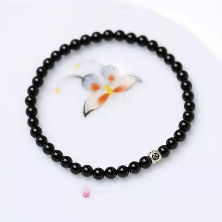 Bracciale Buddha Stones in ossidiana nera naturale e quarzo fumé per la forza di purificazione